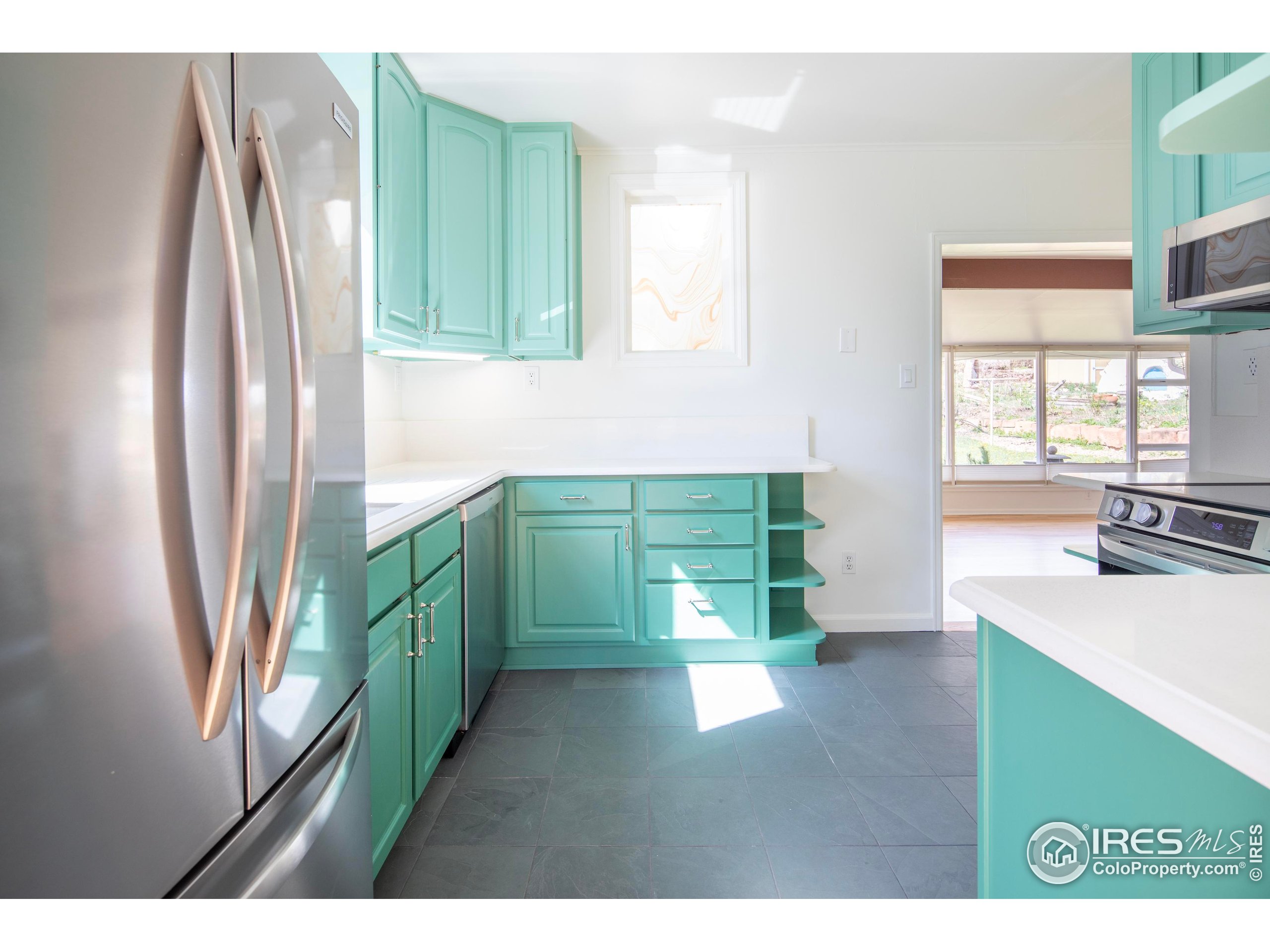 2447 20th Street Boulder, CO 80304 - Photo 6 of 35 a kitchen with window and refrigerator