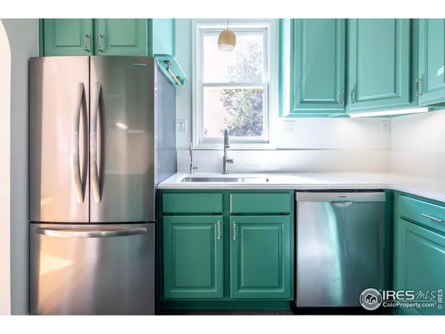 a kitchen with a refrigerator and a sink