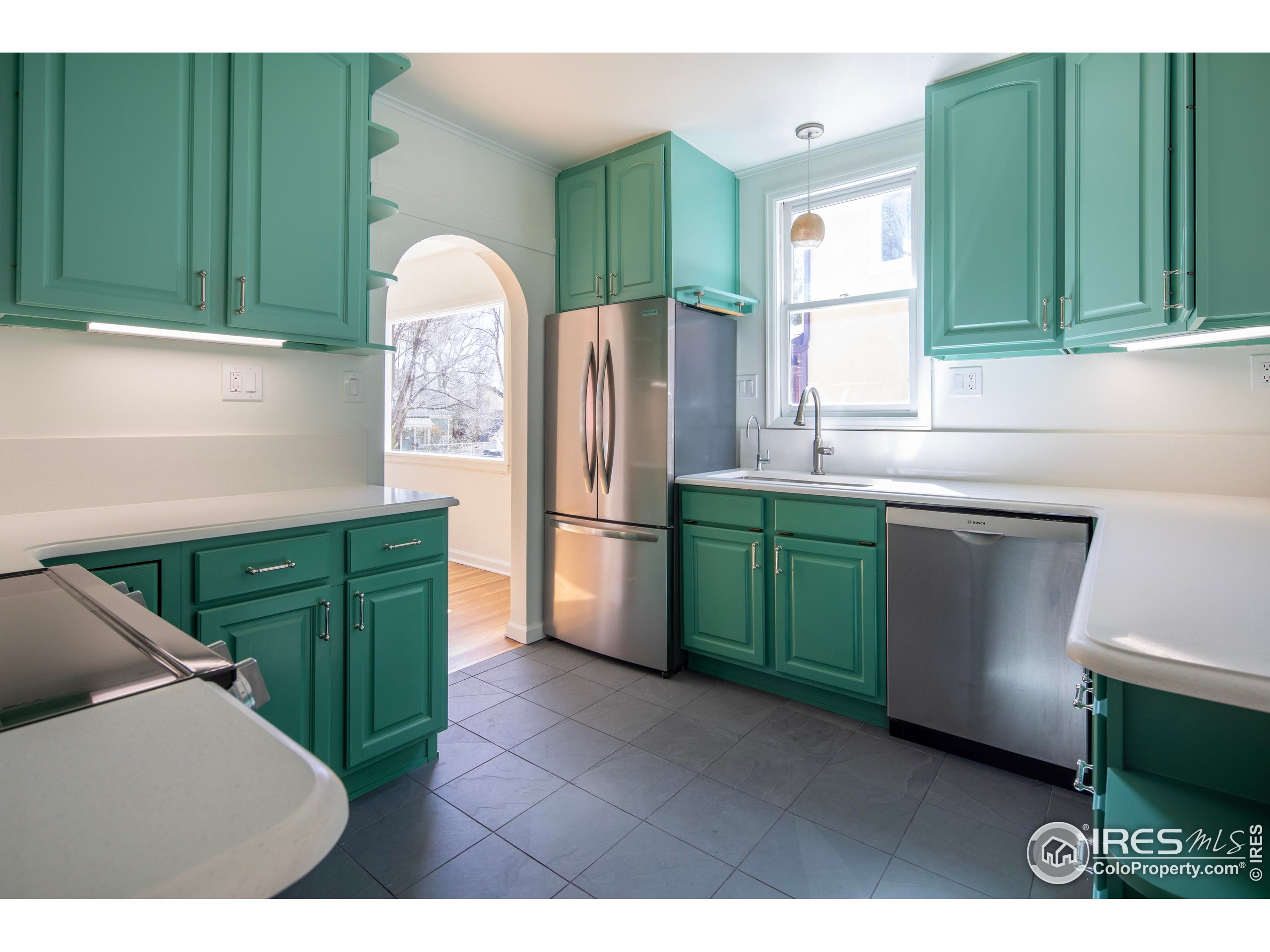 2447 20th Street Boulder, CO 80304 - Photo 9 of 35 a kitchen with refrigerator and cabinets