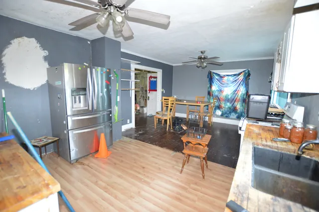 a living room with furniture a dining table and chairs with wooden floor
