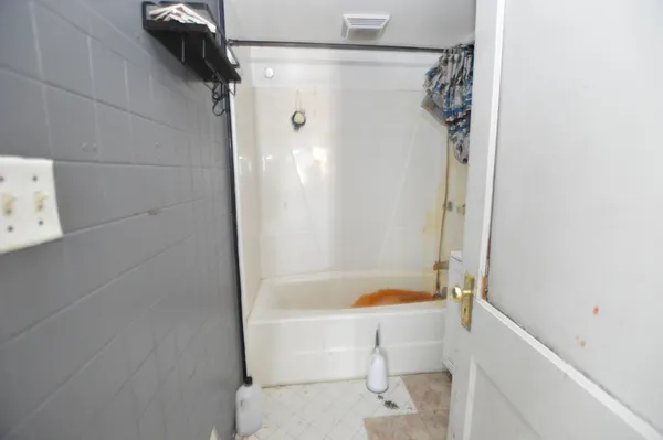 a bathroom with a bathtub and a shower
