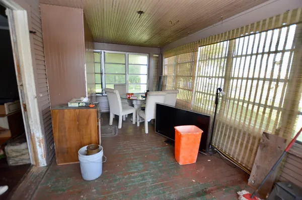 a dining room with furniture and a window