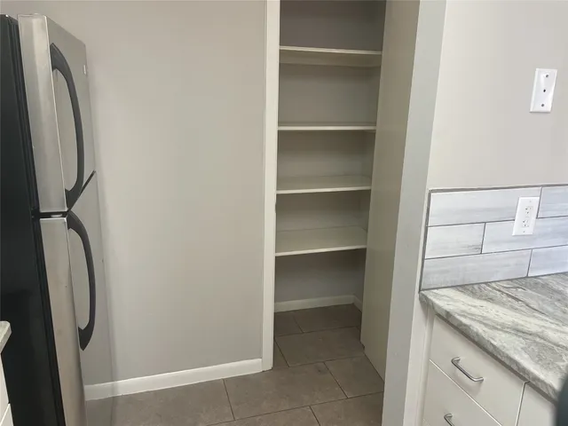 a kitchen with a refrigerator and a sink