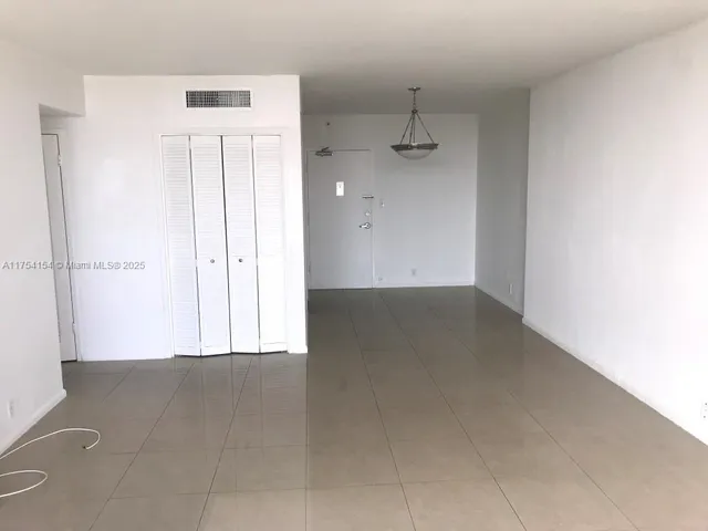 an empty room with a empty space and windows