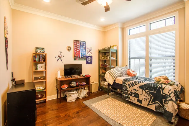 a bedroom with furniture and a flat screen tv