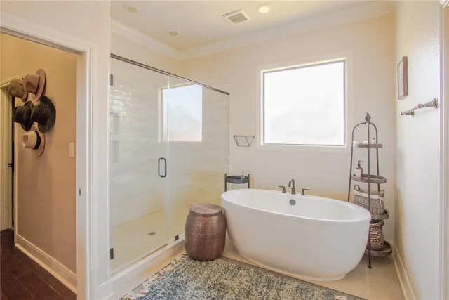 a white tub sitting next to a bathroom sink