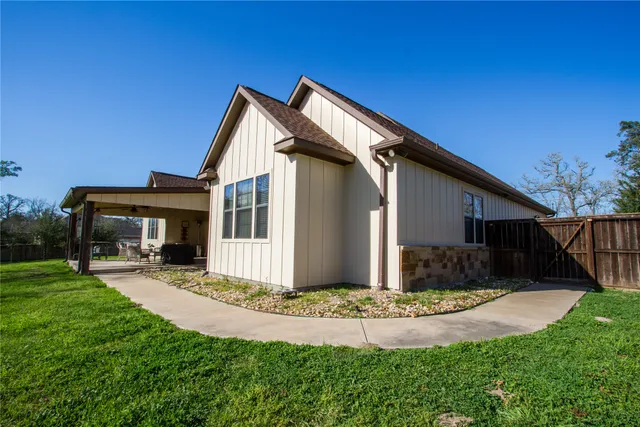 a front view of house with yard and outdoor seating