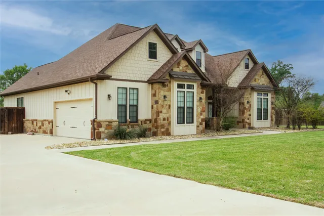 a front view of a house with a yard and porch