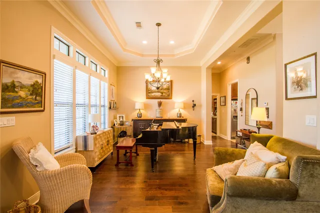 a living room with furniture and a chandelier
