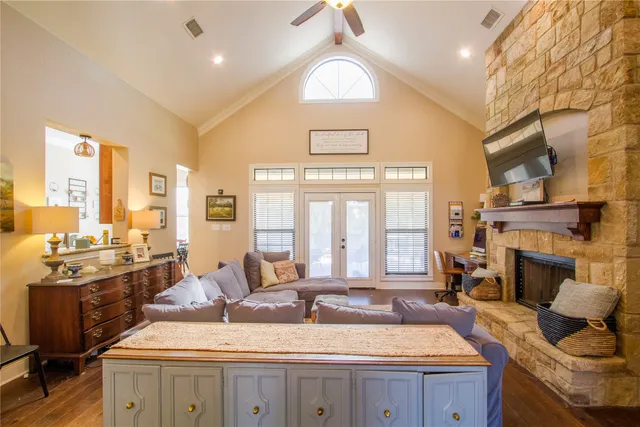 a large living room with fireplace furniture and a large window