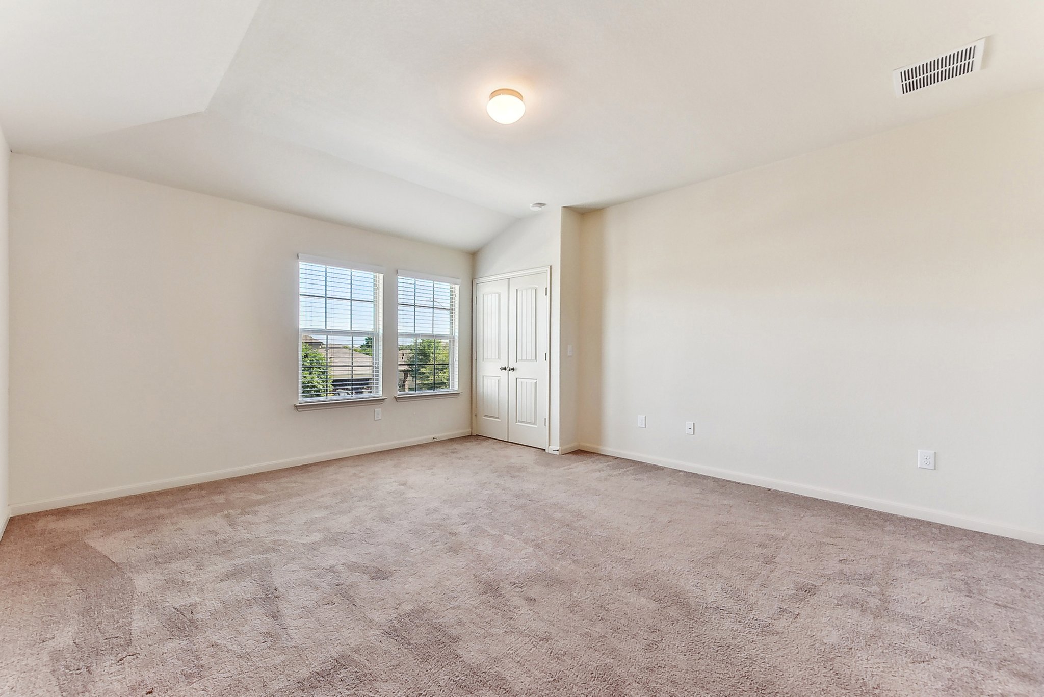 310 Potters Peak Way Georgetown, TX 78626 - Photo 15 of 21 Spacious room featuring vaulted ceilings, a neutral carpeted floor, and two windows with horizontal blinds