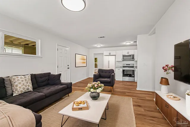 a living room with furniture and a flat screen tv