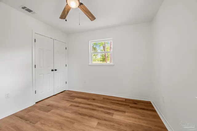 a bedroom with a bed and a potted plant