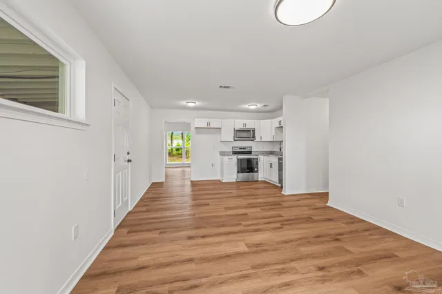 a view of kitchen with wooden floor