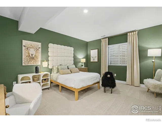 a bedroom with a bed a couch and dresser