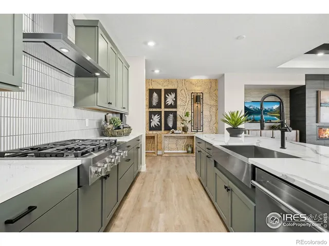 a kitchen with stainless steel appliances granite countertop a stove and a sink