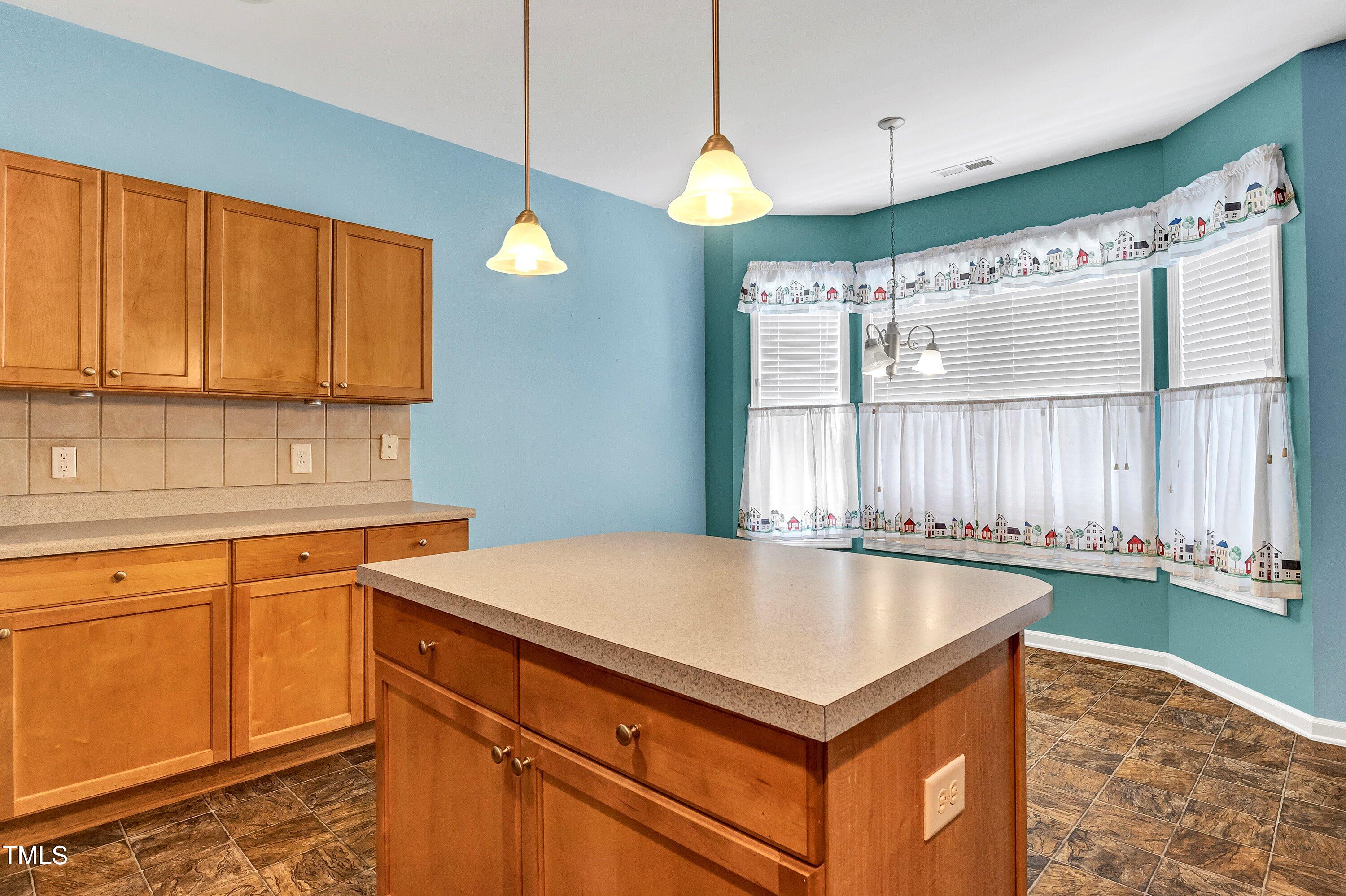3932 Cane Garden Drive Raleigh, NC 27610 - Photo 12 of 34 a kitchen with a stove a sink and a window