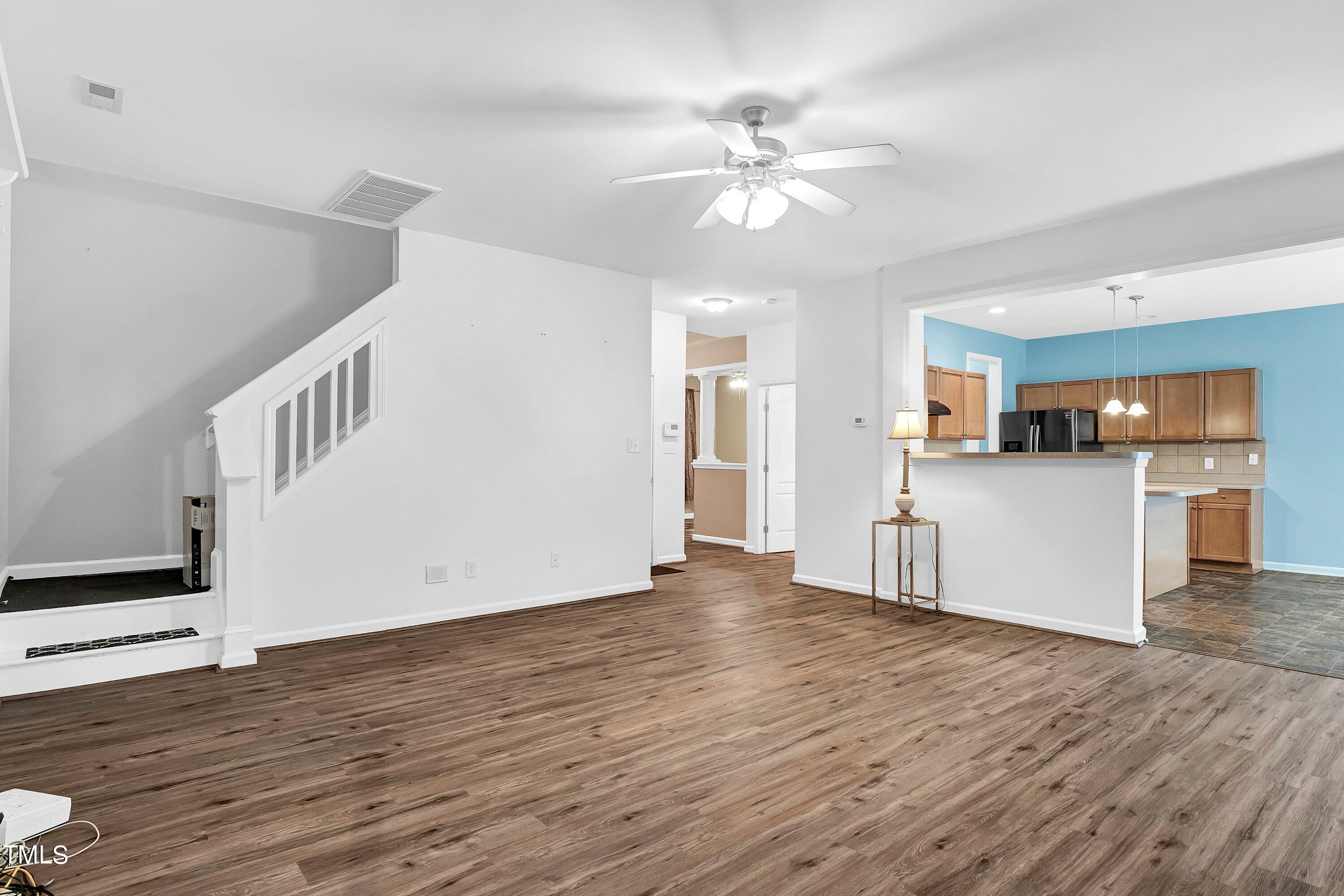 3932 Cane Garden Drive Raleigh, NC 27610 - Photo 17 of 34 a view of a kitchen with wooden floor and an empty room