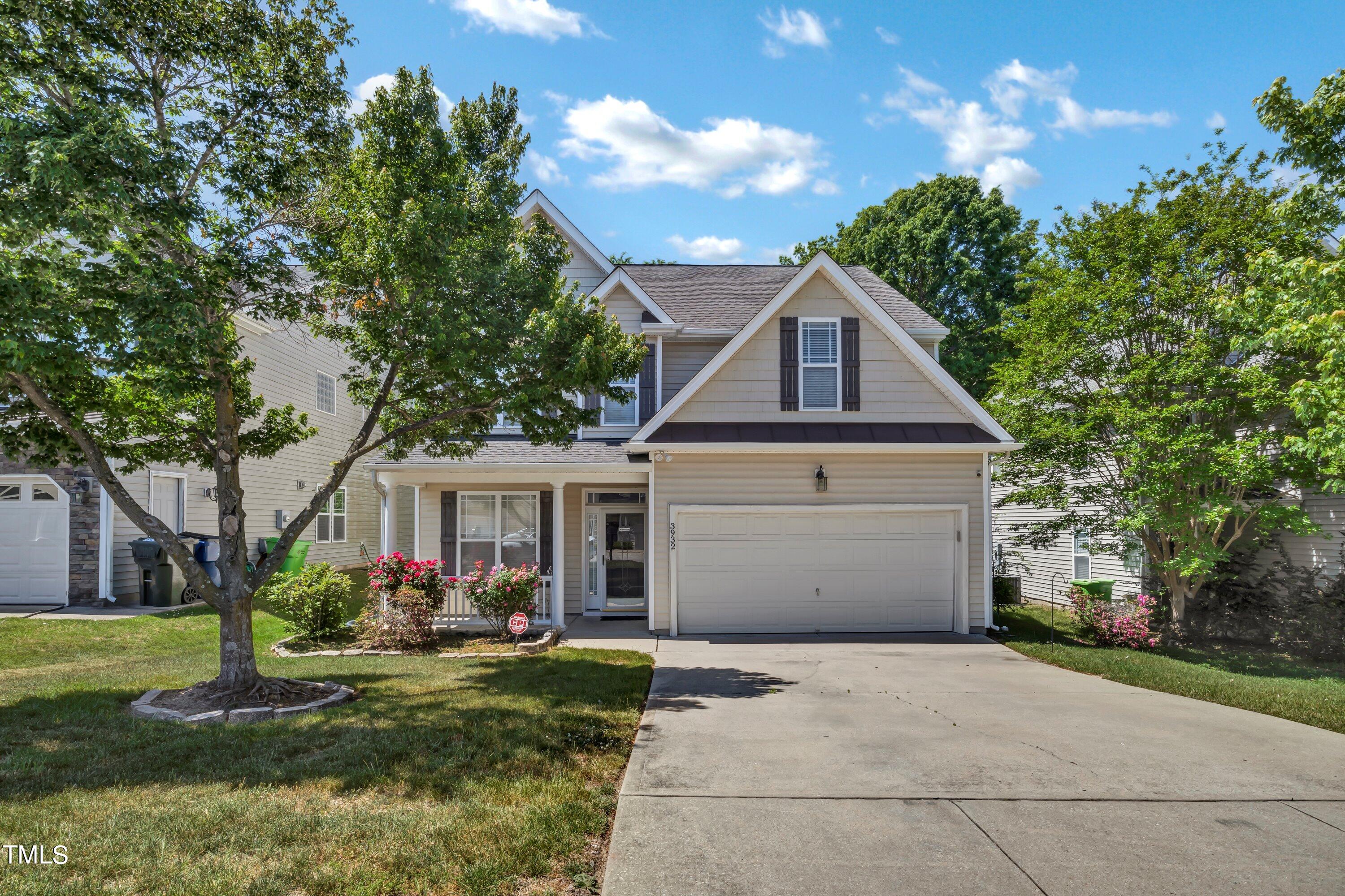 3932 Cane Garden Drive Raleigh, NC 27610 - Photo 2 of 34 a front view of a house with a garden and plants
