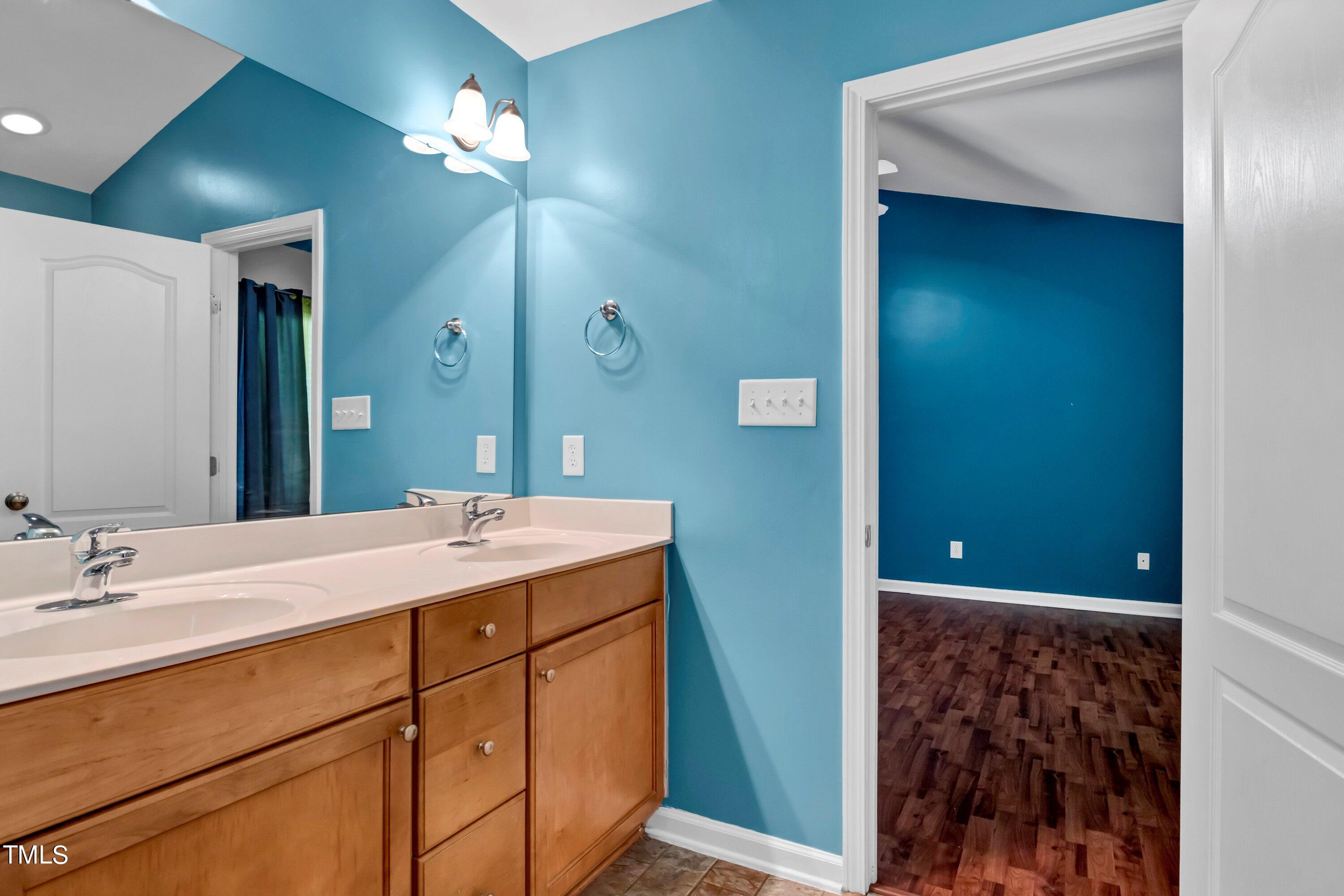 3932 Cane Garden Drive Raleigh, NC 27610 - Photo 23 of 34 a bathroom with a sink vanity and a mirror