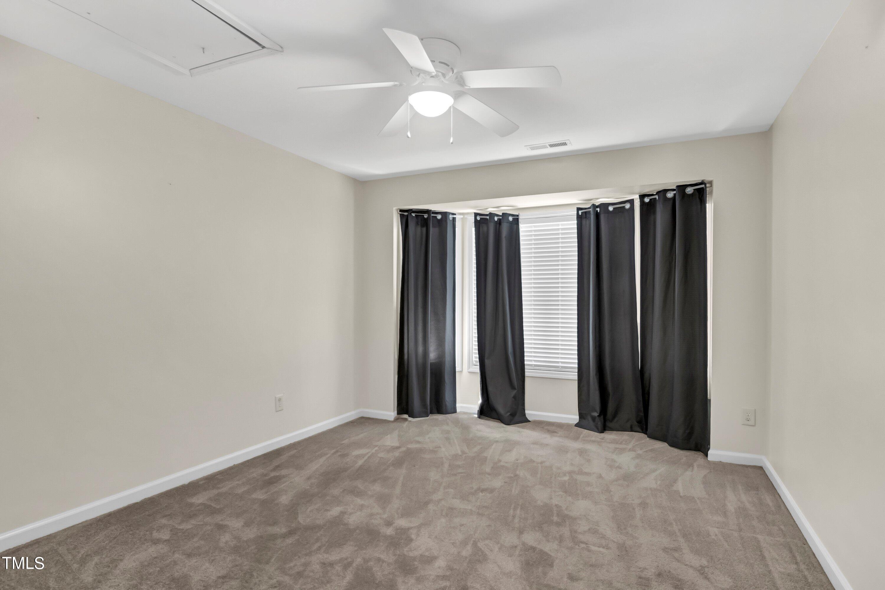 3932 Cane Garden Drive Raleigh, NC 27610 - Photo 25 of 34 an empty room with closet and a ceiling fan