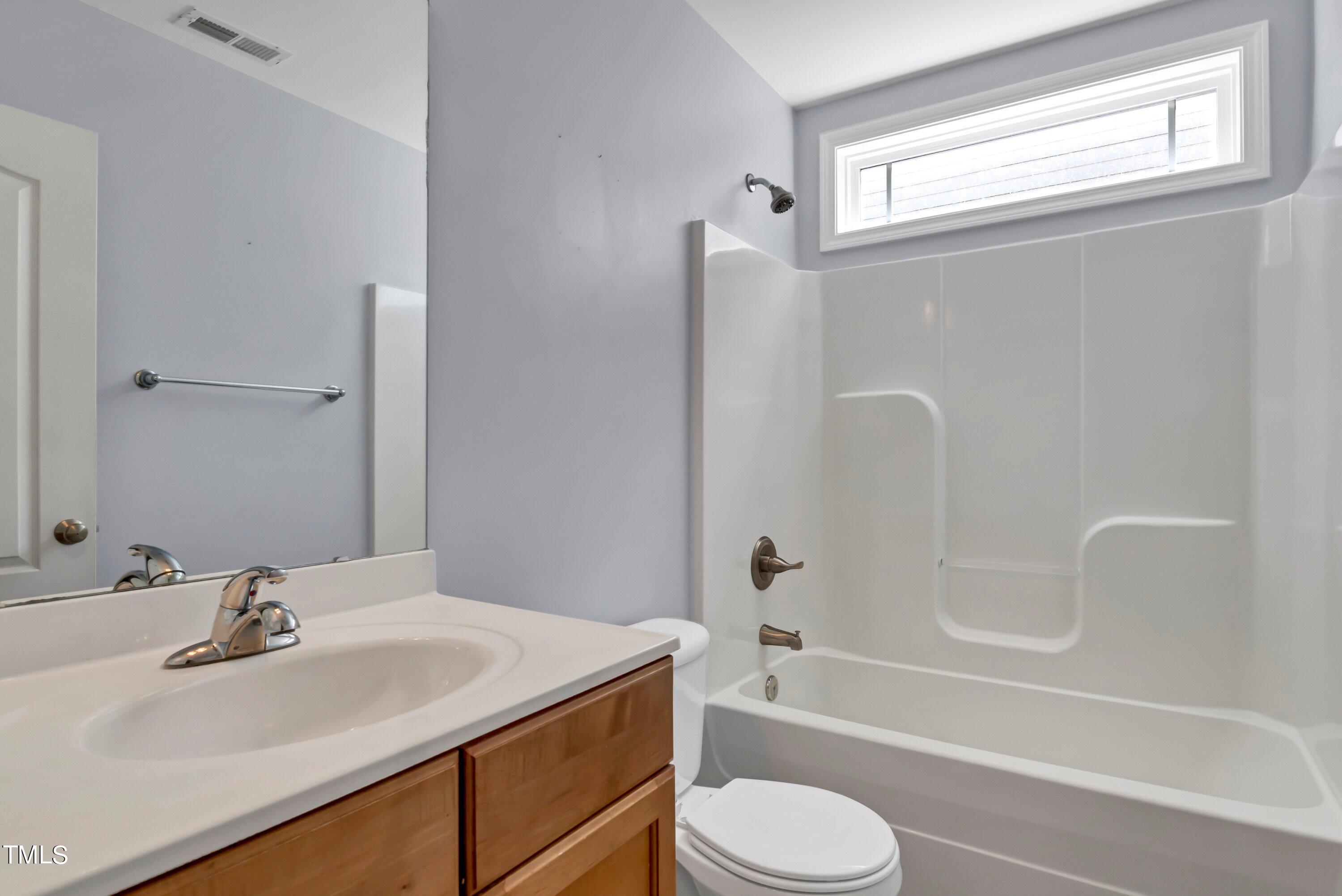 3932 Cane Garden Drive Raleigh, NC 27610 - Photo 26 of 34 a bathroom with a granite countertop sink toilet and shower
