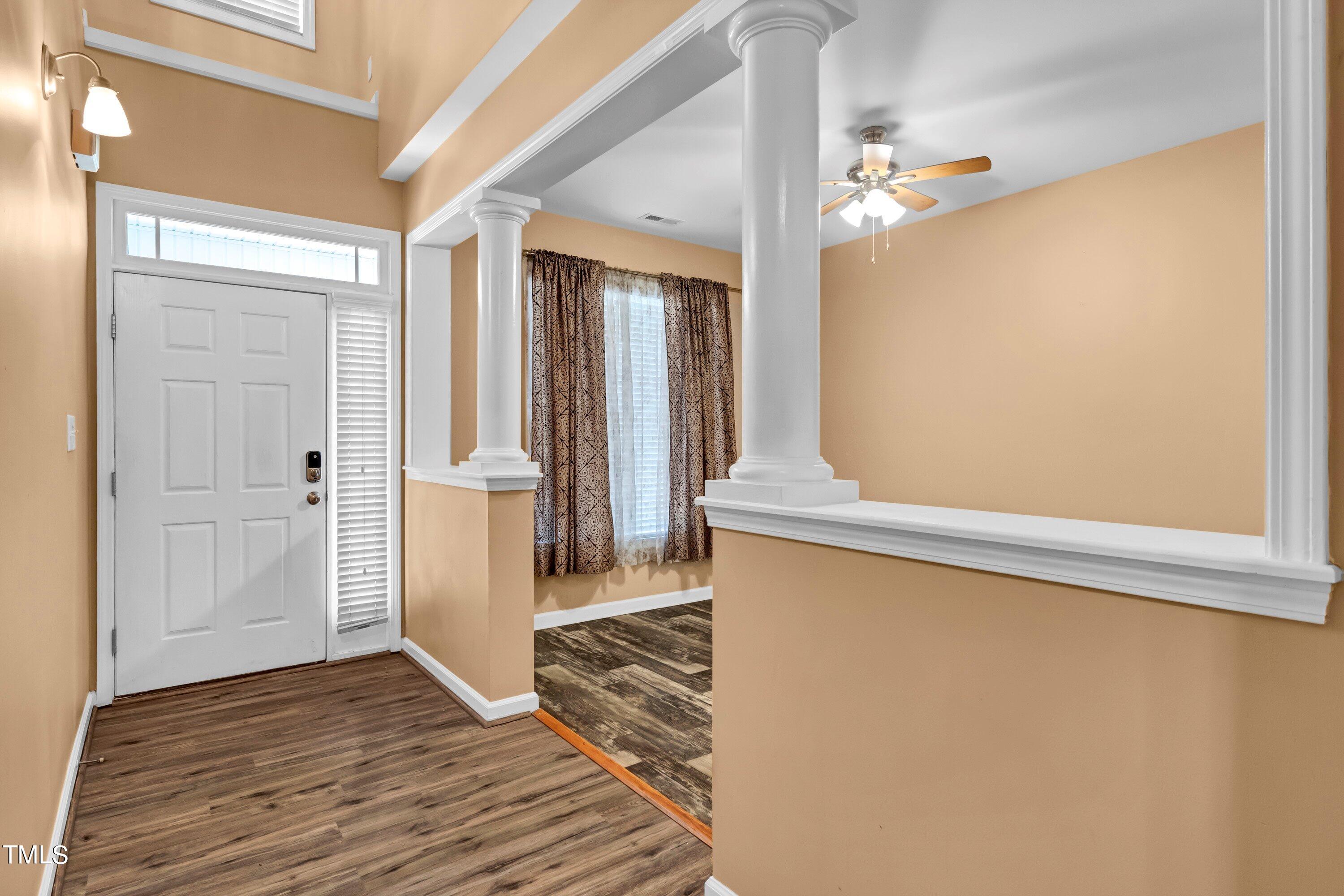 3932 Cane Garden Drive Raleigh, NC 27610 - Photo 5 of 34 a view of a hallway with wooden floor and entryway