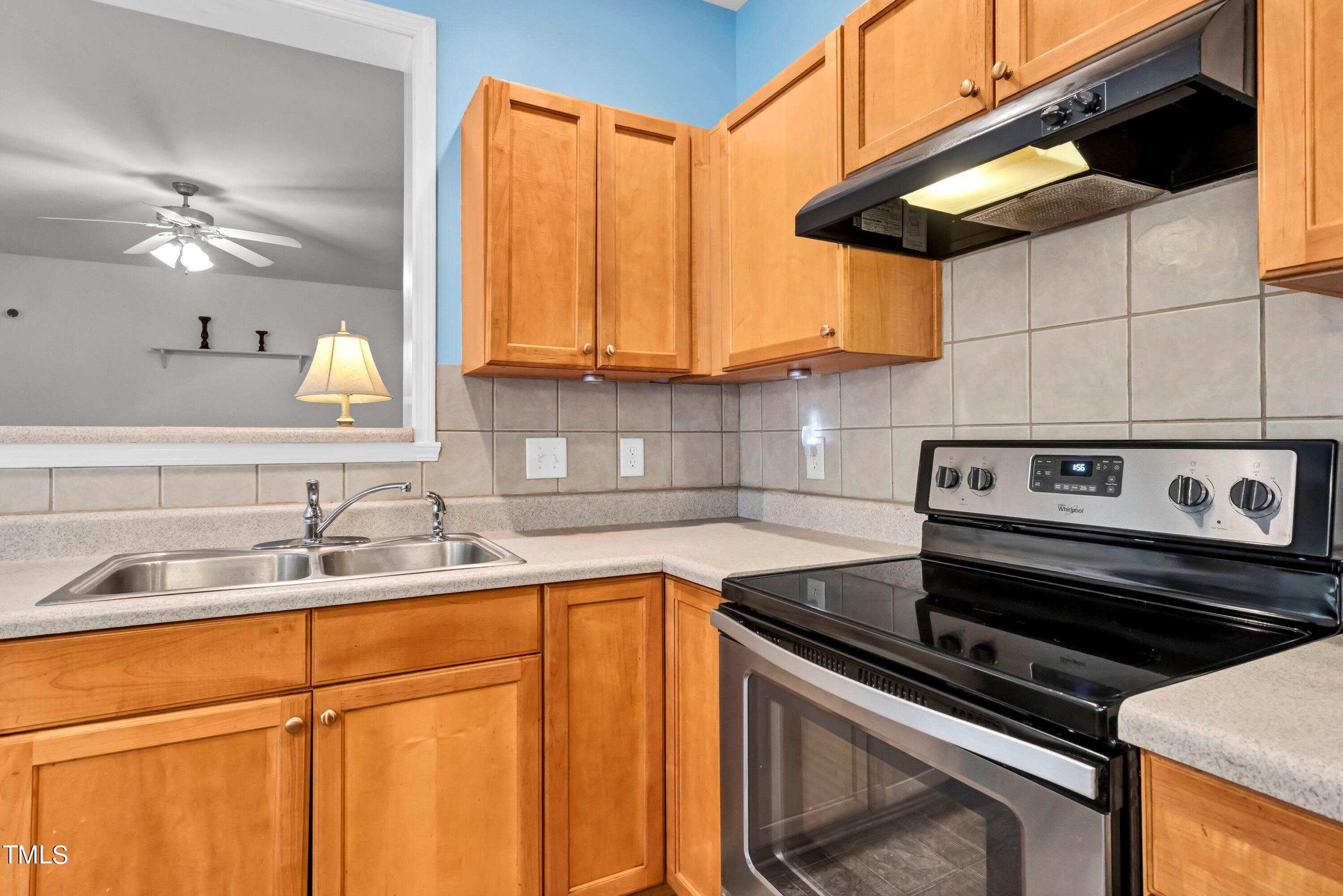 3932 Cane Garden Drive Raleigh, NC 27610 - Photo 9 of 34 a kitchen with stainless steel appliances granite countertop a sink and a stove