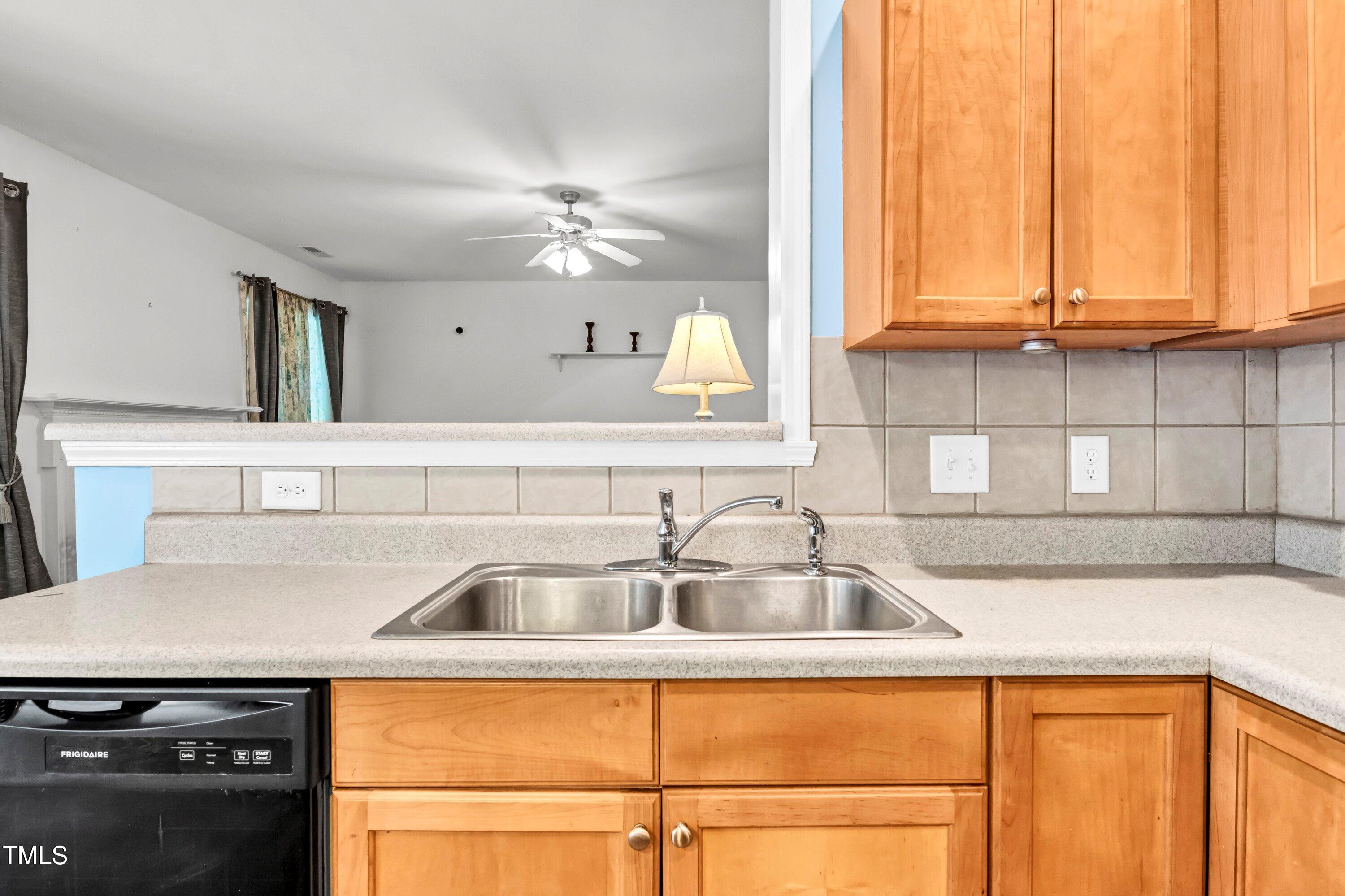 3932 Cane Garden Drive Raleigh, NC 27610 - Photo 10 of 34 a kitchen with a sink and cabinets