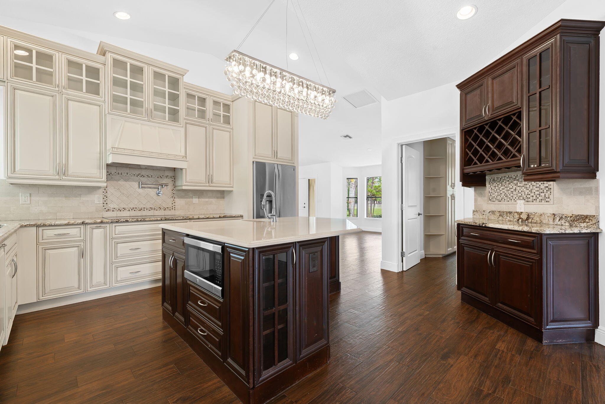 5635 Reynolds Road Lake Worth, FL 33449 - Photo 11 of 40 a kitchen with stainless steel appliances granite countertop a stove a sink dishwasher and a refrigerator with wooden cabinets