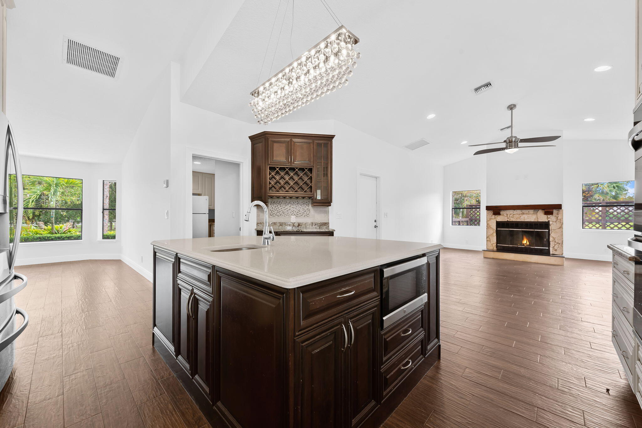 5635 Reynolds Road Lake Worth, FL 33449 - Photo 13 of 40 a kitchen with a sink stove and wooden floor