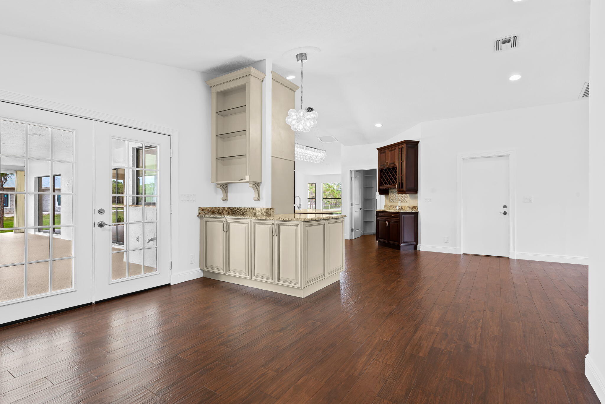 5635 Reynolds Road Lake Worth, FL 33449 - Photo 16 of 40 a view of empty room with wooden floor and windows
