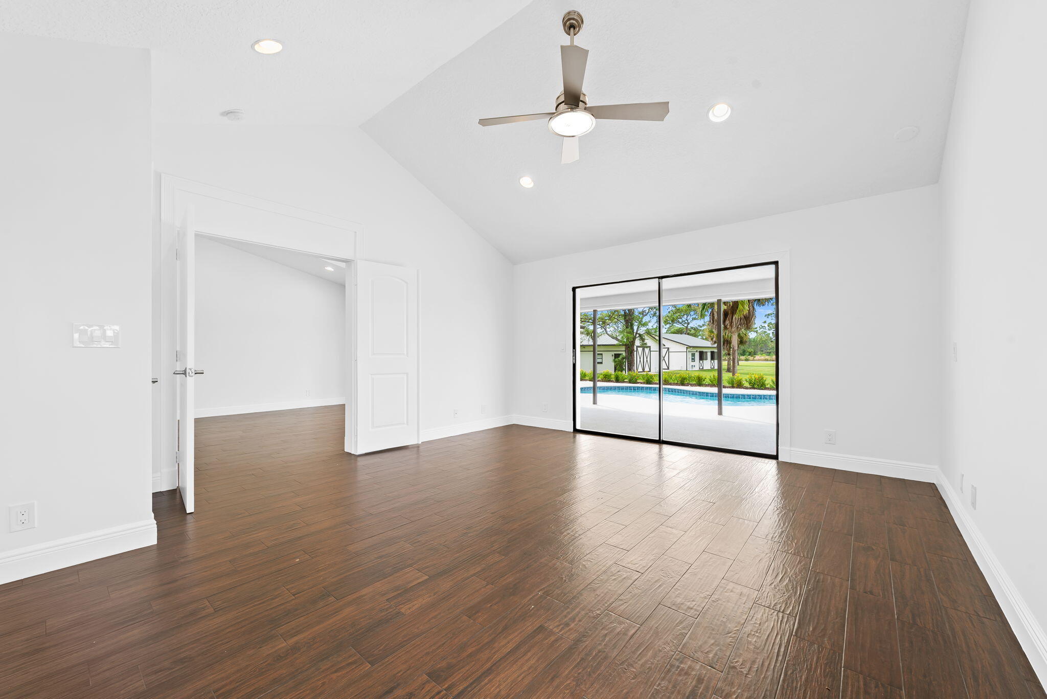 5635 Reynolds Road Lake Worth, FL 33449 - Photo 24 of 40 a view of an empty room with wooden floor and a window
