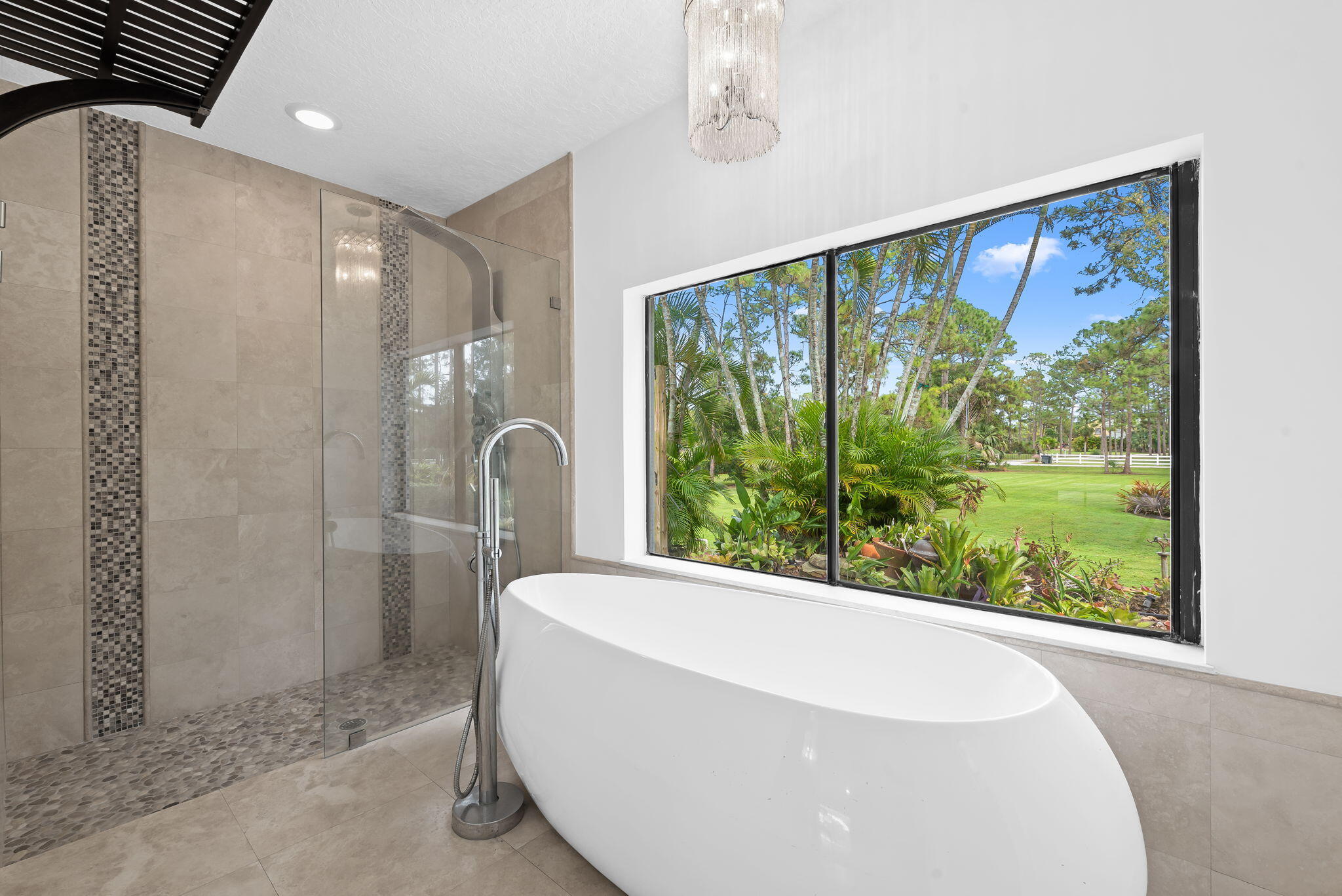 5635 Reynolds Road Lake Worth, FL 33449 - Photo 26 of 40 a white bath tub sitting in a bathroom next to a window