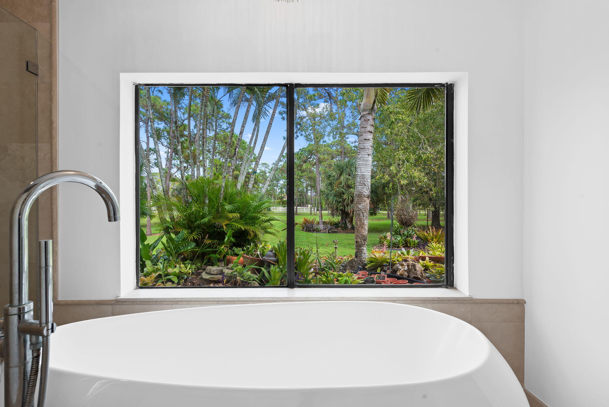 5635 Reynolds Road Lake Worth, FL 33449 - Photo 27 of 40 a view of a large window with a garden space
