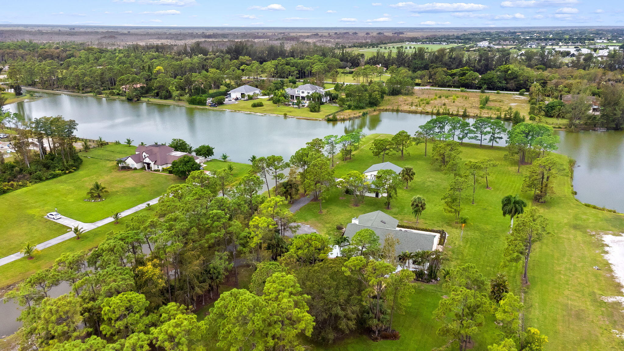 5635 Reynolds Road Lake Worth, FL 33449 - Photo 6 of 40 a view of a lake with a houses with outdoor space