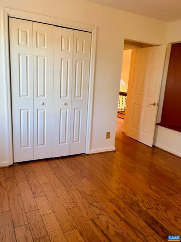 a view of an entryway with wooden floor
