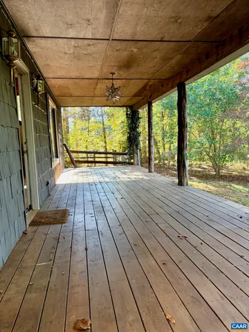a room with wooden floor and windows