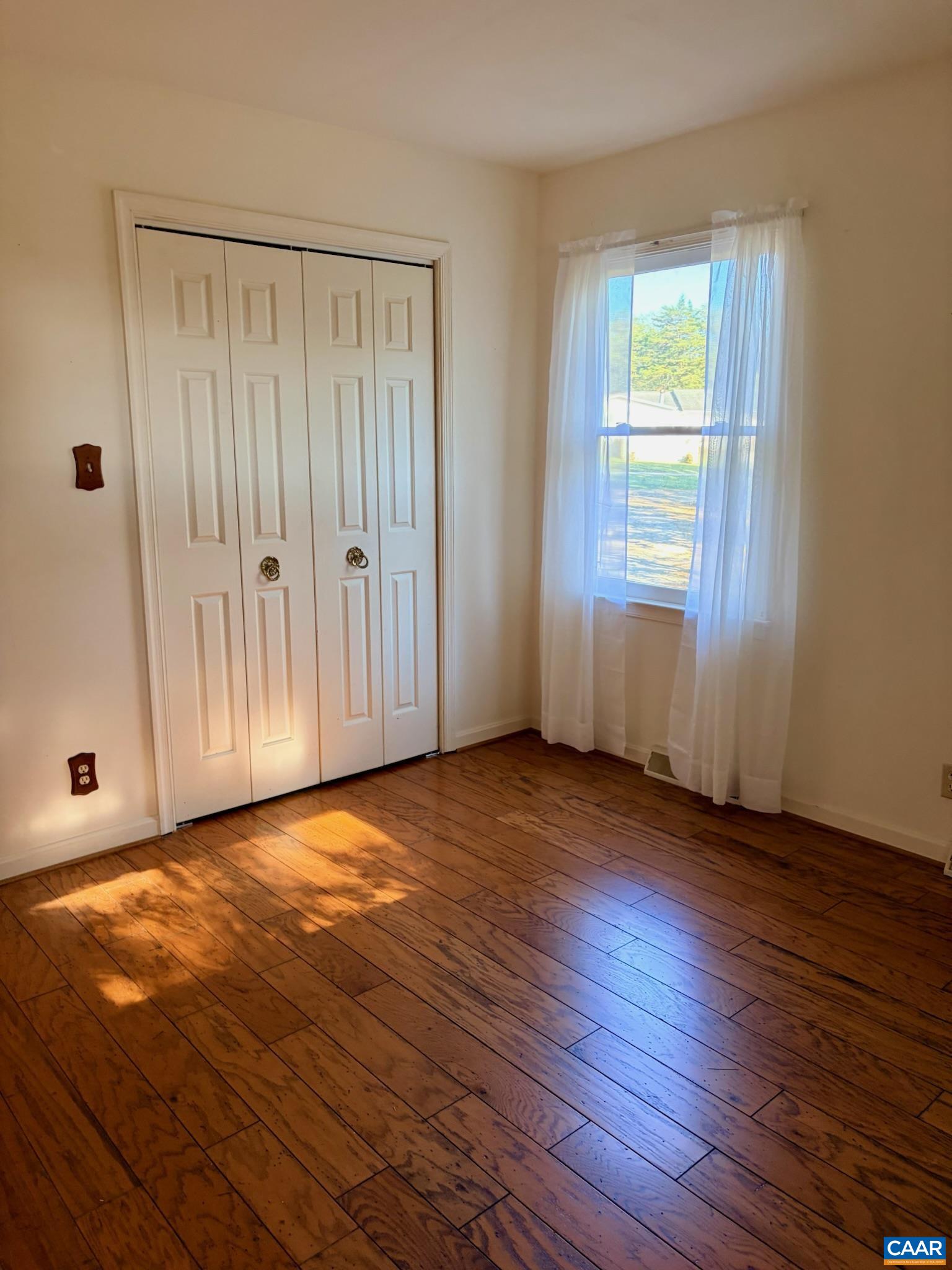 699 Winton Road Amherst, VA 24521 - Photo 31 of 35 a view of an empty room with wooden floor and a window