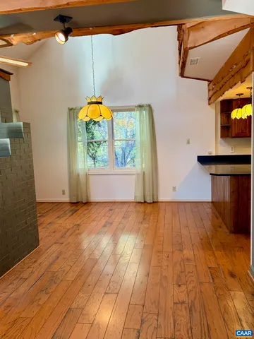 a view of a livingroom with wooden floor and entertaining space
