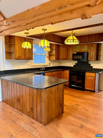 a kitchen with stainless steel appliances kitchen island granite countertop a sink and cabinets