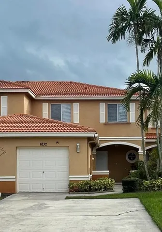 a front view of a house with garage