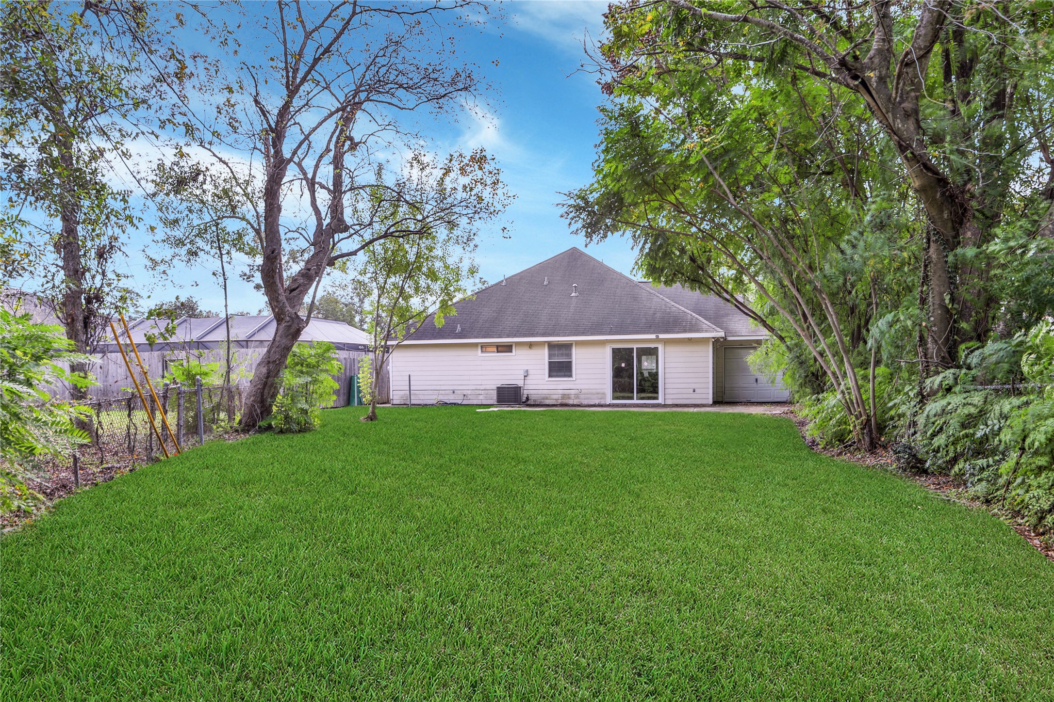 4943 Gammage Street Houston, TX 77021 - Photo 9 of 22 The lush private lawn is fenced for privacy and offers a spacious patio for cook outs and relaxing outside with tree lined views.