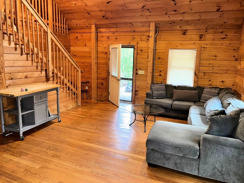 35 Tecumseh Road Wellfleet, MA 02667 - Photo 24 of 24 a living room with furniture a fireplace and a flat screen tv