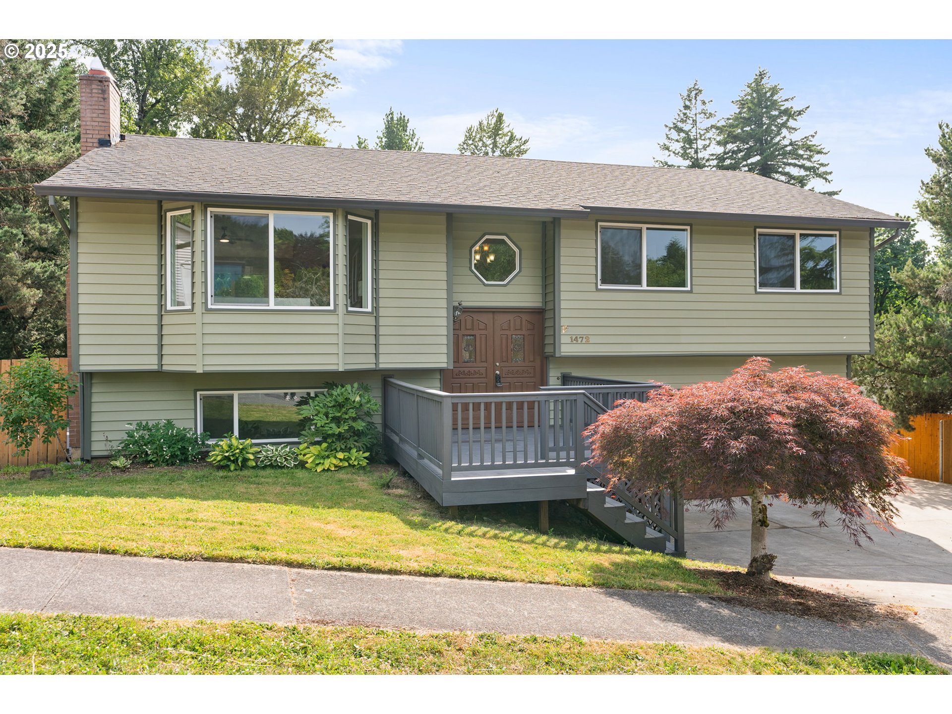 1472 Southwest 14th Street Gresham, OR 97080 - Photo 1 of 32 a view of a house with a wooden deck and a yard