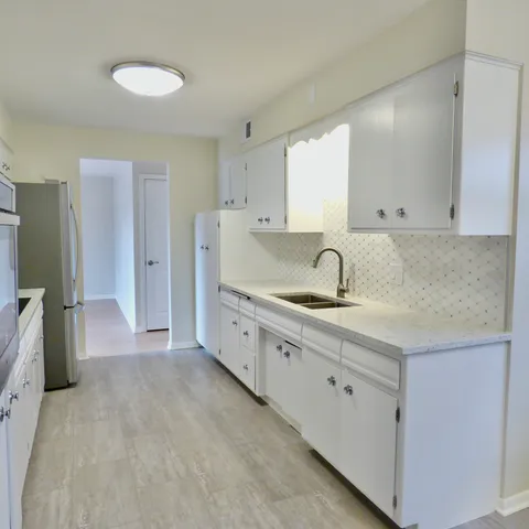 a spacious bathroom with a sink and a mirror