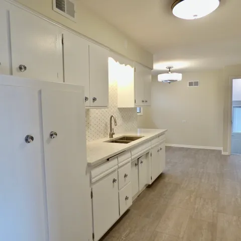 a spacious bathroom with a double vanity sink and a mirror