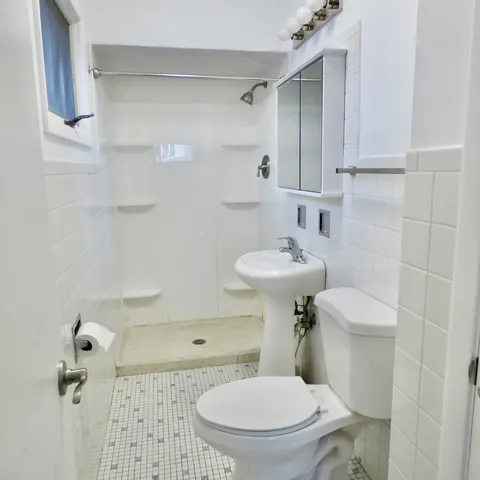 a white toilet sitting next to a bathroom sink