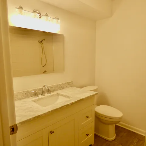 a bathroom with a granite countertop sink and a mirror