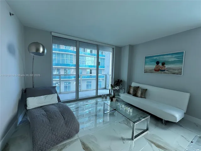 a view of living room filled with furniture and window